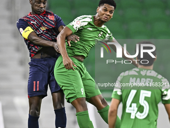 Almoez Abdulla (L) of Al Duhail FC battles for the ball with Sekou Oumar Yansane of Al Ahli SC during the Ooredoo Qatar Stars League 24/25 m...