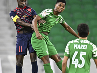 Almoez Abdulla (L) of Al Duhail FC battles for the ball with Sekou Oumar Yansane of Al Ahli SC during the Ooredoo Qatar Stars League 24/25 m...