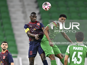 Almoez Abdulla (L) of Al Duhail FC battles for the ball with Sekou Oumar Yansane of Al Ahli SC during the Ooredoo Qatar Stars League 24/25 m...