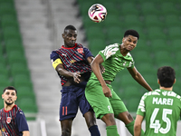 Almoez Abdulla (L) of Al Duhail FC battles for the ball with Sekou Oumar Yansane of Al Ahli SC during the Ooredoo Qatar Stars League 24/25 m...