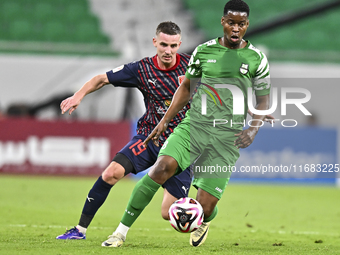 Benjamin Bourigeaud of Al Duhail FC battles for the ball with Idrissa Doumbin of Al Ahli SC during the Ooredoo Qatar Stars League 24/25 matc...