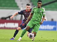 Benjamin Bourigeaud of Al Duhail FC battles for the ball with Idrissa Doumbin of Al Ahli SC during the Ooredoo Qatar Stars League 24/25 matc...