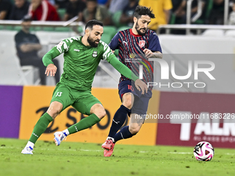 Luis Alberto of Al Duhail FC battles for the ball with Driss Fettouhi of Al Ahli SC during the Ooredoo Qatar Stars League 24/25 match betwee...