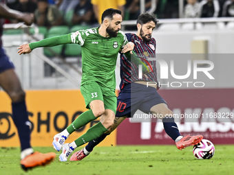 Luis Alberto of Al Duhail FC battles for the ball with Driss Fettouhi of Al Ahli SC during the Ooredoo Qatar Stars League 24/25 match betwee...