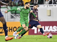 Luis Alberto of Al Duhail FC battles for the ball with Driss Fettouhi of Al Ahli SC during the Ooredoo Qatar Stars League 24/25 match betwee...