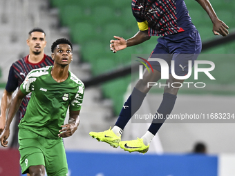 Almoez Abdulla (R) of Al Duhail FC battles for the ball with Sekou Oumar Yansane of Al Ahli SC during the Ooredoo Qatar Stars League 24/25 m...