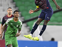 Almoez Abdulla (R) of Al Duhail FC battles for the ball with Sekou Oumar Yansane of Al Ahli SC during the Ooredoo Qatar Stars League 24/25 m...