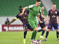 Almoez Abdulla of Al Duhail FC battles for the ball with Julian Draxler of Al Ahli SC during the Ooredoo Qatar Stars League 24/25 match betw...