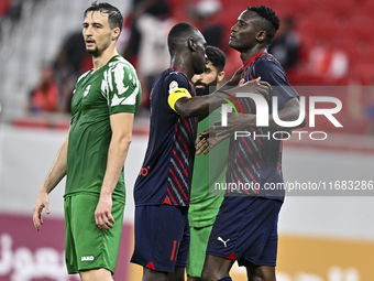 Michael Olunga (R) of Al Duhail FC celebrates with his teammate after scoring a goal during the Ooredoo Qatar Stars League 24/25 match betwe...