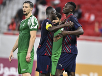 Michael Olunga (R) of Al Duhail FC celebrates with his teammate after scoring a goal during the Ooredoo Qatar Stars League 24/25 match betwe...