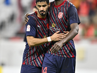 Michael Olunga (R) of Al Duhail FC celebrates with his teammate after scoring a goal during the Ooredoo Qatar Stars League 24/25 match betwe...