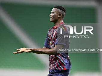 Michael Olunga (R) of Al Duhail FC celebrates after scoring a goal during the Ooredoo Qatar Stars League 24/25 match between Al Ahli SC and...