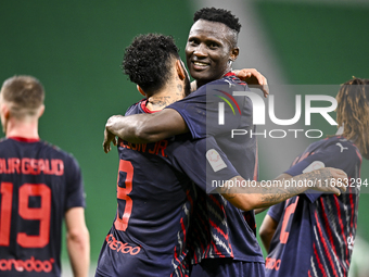 Michael Olunga (R) of Al Duhail FC celebrates with his teammate after scoring a goal during the Ooredoo Qatar Stars League 24/25 match betwe...