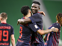 Michael Olunga (R) of Al Duhail FC celebrates with his teammate after scoring a goal during the Ooredoo Qatar Stars League 24/25 match betwe...