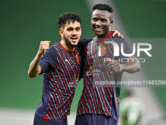 Michael Olunga (R) of Al Duhail FC celebrates with his teammate after scoring a goal during the Ooredoo Qatar Stars League 24/25 match betwe...