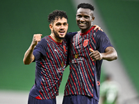 Michael Olunga (R) of Al Duhail FC celebrates with his teammate after scoring a goal during the Ooredoo Qatar Stars League 24/25 match betwe...