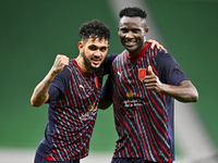 Michael Olunga (R) of Al Duhail FC celebrates with his teammate after scoring a goal during the Ooredoo Qatar Stars League 24/25 match betwe...