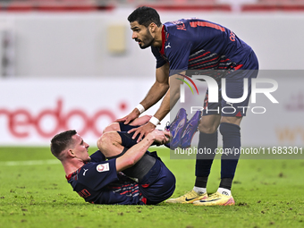 Sultan Al-Brake (right) and Benjamin Bourigeaud (left) of Al Duhail FC react during the Ooredoo Qatar Stars League 24/25 match between Al Ah...