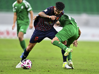 Edmilson Junior Paulo of Al Duhail FC battles for the ball with Abdelrhman Mohamed Moustafa of Al Ahli SC during the Ooredoo Qatar Stars Lea...