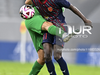 Almoez Abdulla (R) of Al Duhail FC battles for the ball with Talal Abdulla Bahzad of Al Ahli SC during the Ooredoo Qatar Stars League 24/25...