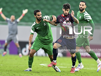 Luis Alberto (R) of Al Duhail FC battles for the ball with Talal Abdulla Bahzad of Al Ahli SC during the Ooredoo Qatar Stars League 24/25 ma...