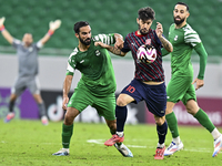 Luis Alberto (R) of Al Duhail FC battles for the ball with Talal Abdulla Bahzad of Al Ahli SC during the Ooredoo Qatar Stars League 24/25 ma...