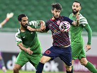 Luis Alberto (R) of Al Duhail FC battles for the ball with Talal Abdulla Bahzad of Al Ahli SC during the Ooredoo Qatar Stars League 24/25 ma...