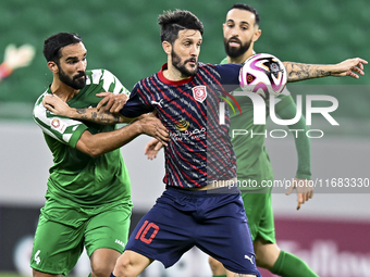 Luis Alberto (R) of Al Duhail FC battles for the ball with Talal Abdulla Bahzad of Al Ahli SC during the Ooredoo Qatar Stars League 24/25 ma...