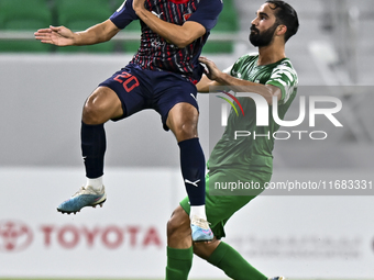 Abdullah Al Ahrak of Al Duhail FC battles for the ball with Talal Abdulla Bahzad of Al Ahli SC during the Ooredoo Qatar Stars League 24/25 m...