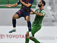 Abdullah Al Ahrak of Al Duhail FC battles for the ball with Talal Abdulla Bahzad of Al Ahli SC during the Ooredoo Qatar Stars League 24/25 m...