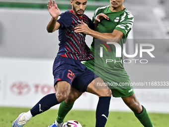 Abdullah Al Ahrak of Al Duhail FC battles for the ball with Yousef Zeyad Marel of Al Ahli SC during the Ooredoo Qatar Stars League 24/25 mat...