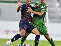 Abdullah Al Ahrak of Al Duhail FC battles for the ball with Yousef Zeyad Marel of Al Ahli SC during the Ooredoo Qatar Stars League 24/25 mat...