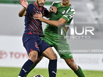 Abdullah Al Ahrak of Al Duhail FC battles for the ball with Yousef Zeyad Marel of Al Ahli SC during the Ooredoo Qatar Stars League 24/25 mat...