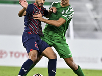 Abdullah Al Ahrak of Al Duhail FC battles for the ball with Yousef Zeyad Marel of Al Ahli SC during the Ooredoo Qatar Stars League 24/25 mat...