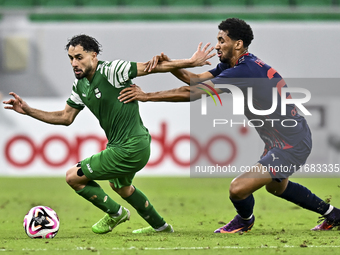 Abdullah Al Ahrak of Al Duhail FC battles for the ball with Abdelrhman Mohamed Moustafa of Al Ahli SC during the Ooredoo Qatar Stars League...