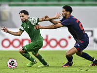 Abdullah Al Ahrak of Al Duhail FC battles for the ball with Abdelrhman Mohamed Moustafa of Al Ahli SC during the Ooredoo Qatar Stars League...