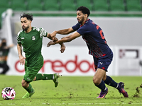 Abdullah Al Ahrak of Al Duhail FC battles for the ball with Abdelrhman Mohamed Moustafa of Al Ahli SC during the Ooredoo Qatar Stars League...