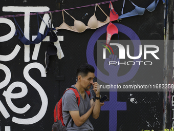 A person stands in front of a clothesline of bras at the Glorieta de las Mujeres que Luchan in Mexico City, Mexico, on October 19, 2024. Thi...