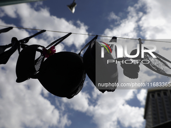 A clothesline of bras is placed at the Glorieta de las Mujeres que Luchan in Mexico City, Mexico, on October 19, 2024, by women who survive...