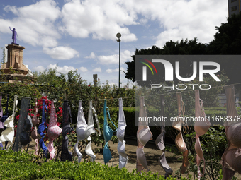 A clothesline of bras is placed at the Glorieta de las Mujeres que Luchan in Mexico City, Mexico, on October 19, 2024, by women who survive...