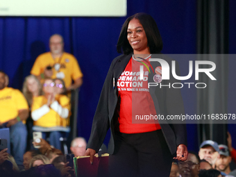 Waterford, MICHIGAN - OCTOBER 18: Michigan Moms Demand Action volunteer and gun violence survivor Mia Reid walks onto the stage to speak and...