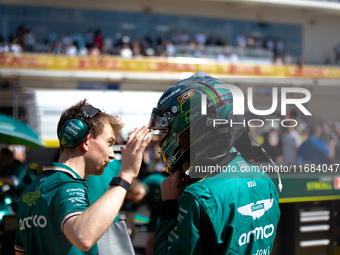 Lance Stroll secures his helmet ahead of a sprint race at Circuit of the Americas in Austin, Texas, on October 19, 2024, during the Formula...