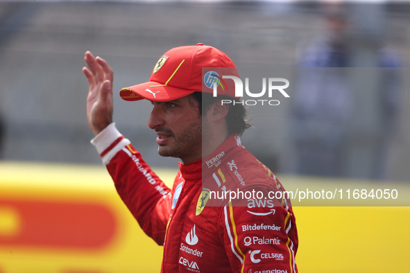 Carlos Sainz waves to fans after driving in a sprint race at Circuit of the Americas in Austin, Texas, on October 19, 2024, during the Formu...