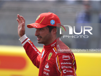 Carlos Sainz waves to fans after driving in a sprint race at Circuit of the Americas in Austin, Texas, on October 19, 2024, during the Formu...