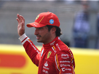 Carlos Sainz waves to fans after driving in a sprint race at Circuit of the Americas in Austin, Texas, on October 19, 2024, during the Formu...