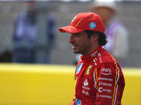 Carlos Sainz waves to fans after driving in a sprint race at Circuit of the Americas in Austin, Texas, on October 19, 2024, during the Formu...