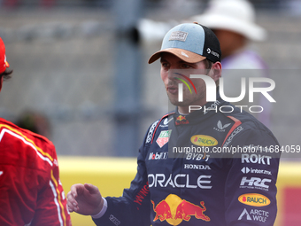 Carlos Sainz and Max Verstappen speak after finishing a sprint race at Circuit of the Americas in Austin, Texas, on October 19, 2024, during...