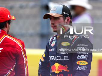 Carlos Sainz and Max Verstappen speak after finishing a sprint race at Circuit of the Americas in Austin, Texas, on October 19, 2024, during...