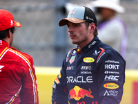 Carlos Sainz and Max Verstappen speak after finishing a sprint race at Circuit of the Americas in Austin, Texas, on October 19, 2024, during...