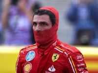 Carlos Sainz emerges from his car after winning a sprint race at Circuit of the Americas in Austin, Texas, on October 19, 2024, during the F...